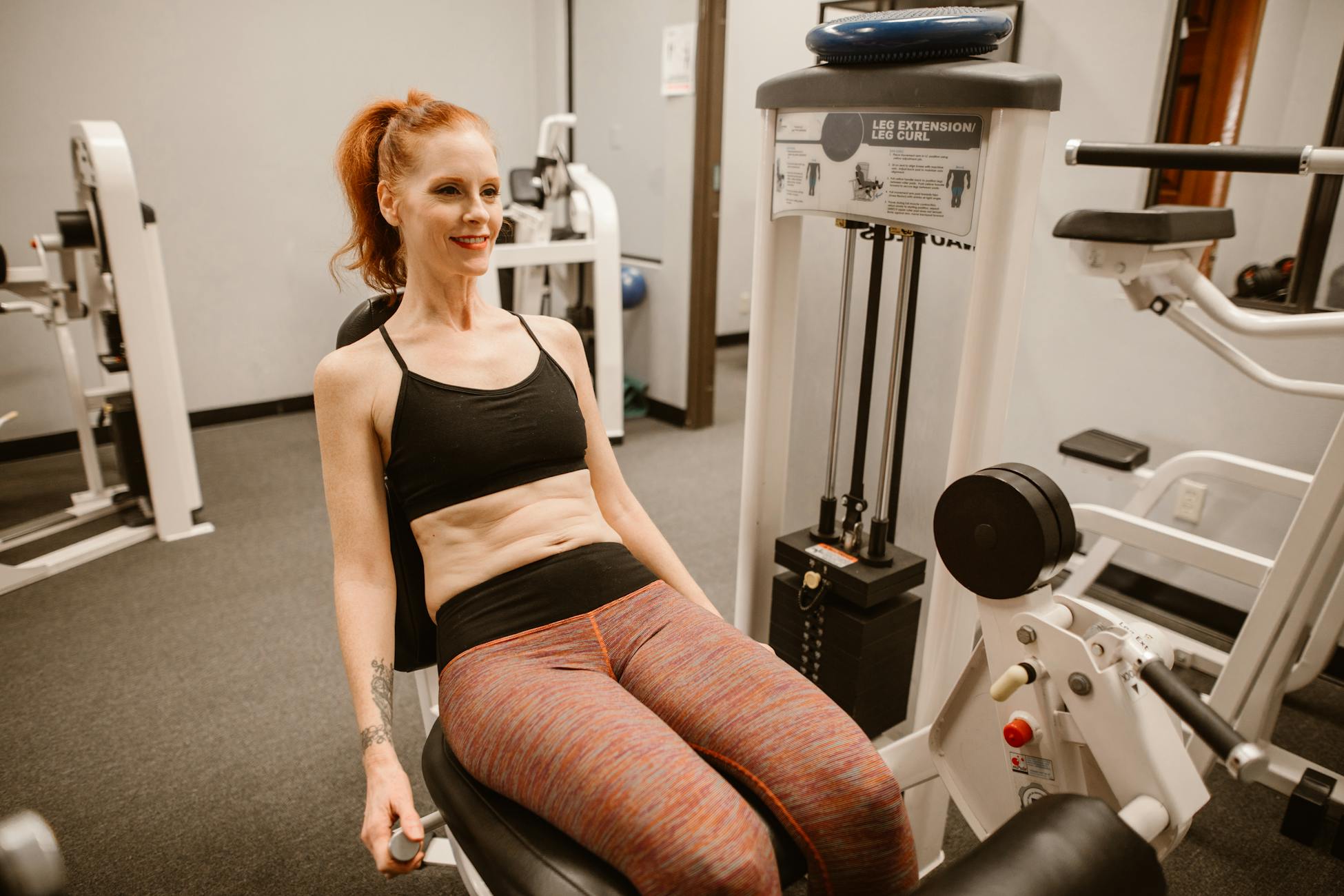 Woman performing leg workout in gym, showcasing fitness and health lifestyle.